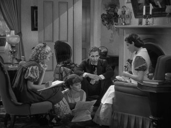 Movie still from “Little Women” (1933), directed by George Cukor – A group of people sitting in a living room together; Wide shot, High angle