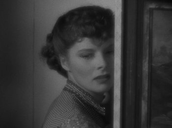 Movie still from “Little Women” (1933), directed by George Cukor – A black - and - white photo of a woman looking out of a window; Close Up shot, High angle