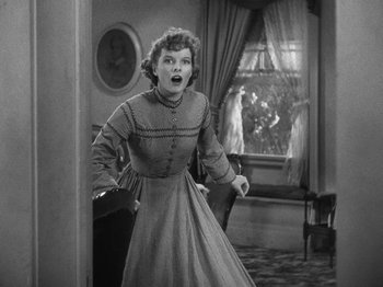 Movie still from “Little Women” (1933), directed by George Cukor – An old photo of a woman in an old fashioned dress; Medium shot, Low angle