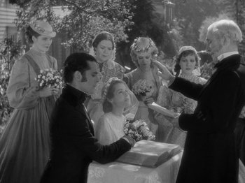Movie still from “Little Women” (1933), directed by George Cukor – A group of people standing next to each other on a table; Medium shot, Over the shoulder angle