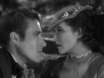 Movie still from “Little Women” (1933), directed by George Cukor – A man and a woman face to face in a black and white photo; Close Up shot, High angle