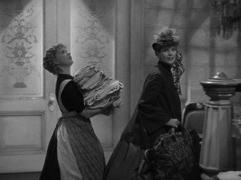 Movie still from “Little Women” (1933), directed by George Cukor – Two women dressed in old fashion clothes and hats; Medium shot, High angle