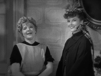 Movie still from “Little Women” (1933), directed by George Cukor – Two women dressed up and posing for a picture; Medium shot, Over the shoulder angle