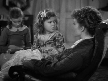 Movie still from “Little Women” (1933), directed by George Cukor – A black and white photo of a woman and two children; Medium shot, High angle