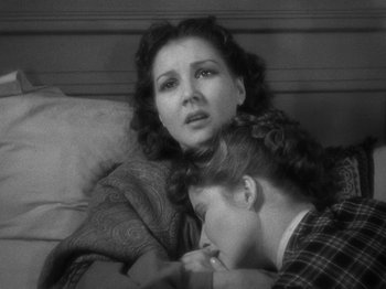 Movie still from “Little Women” (1933), directed by George Cukor – A woman and a man laying on a bed; Close Up shot, High angle