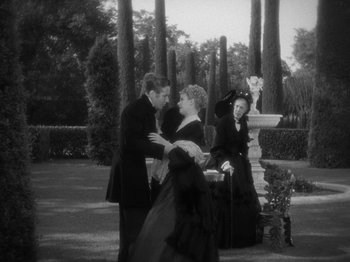 Movie still from “Little Women” (1933), directed by George Cukor – A black and white photo of a man and a woman; Wide shot, High angle