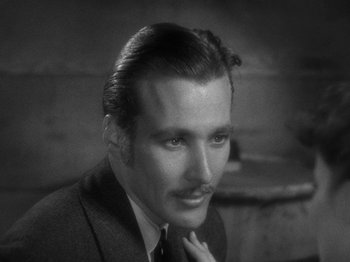 Movie still from “Little Women” (1933), directed by George Cukor – A man in a suit and tie with a mustache; Close Up shot, High angle
