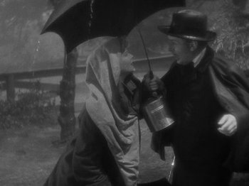 Movie still from “Little Women” (1933), directed by George Cukor – A man and a woman holding an open umbrella; Medium shot, High angle