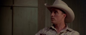 Movie still from “Lone Star” (1996), directed by John Sayles – A man wearing a cowboy hat looking to his left; Close Up shot, Over the shoulder angle