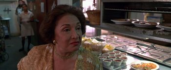 Movie still from “Lone Star” (1996), directed by John Sayles – An older woman sitting in front of a table full of food; Close Up shot, Low angle