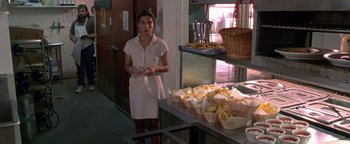 Movie still from “Lone Star” (1996), directed by John Sayles – A woman standing in front of baskets of bananas; Medium shot, Over the shoulder angle