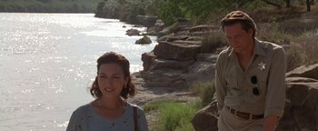 Movie still from “Lone Star” (1996), directed by John Sayles – A woman standing next to a man near a body of water; Medium shot, Over the shoulder angle