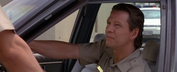 Movie still from “Lone Star” (1996), directed by John Sayles – A man sitting in the drivers seat of a car; Close Up shot, Low angle