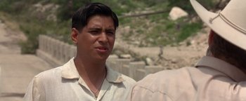 Movie still from “Lone Star” (1996), directed by John Sayles – A man in a white shirt is standing outside; Close Up shot, Over the shoulder angle