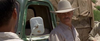 Movie still from “Lone Star” (1996), directed by John Sayles – A man in a cowboy hat sitting in the driver's seat of an old truck; Close Up shot, Low angle
