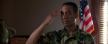 Movie still from “Lone Star” (1996), directed by John Sayles – A soldier saluting while saluting with one hand on his forehead; Close Up shot, Low angle