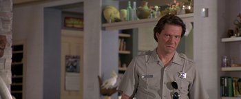 Movie still from “Lone Star” (1996), directed by John Sayles – A man standing in a living room; Close Up shot, Low angle