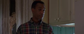 Movie still from “Lone Star” (1996), directed by John Sayles – A person wearing a plaid shirt; Close Up shot, Over the shoulder angle