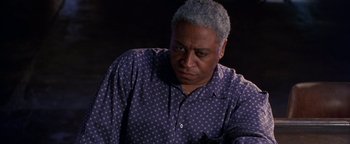 Movie still from “Lone Star” (1996), directed by John Sayles – An older man in a polka dot shirt looking sad; Close Up shot, Low angle