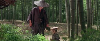 Movie still from “Lone Wolf and Cub: Baby Cart to Hades” (1972), directed by Kenji Misumi – A man and a little boy in a bamboo forest; Wide shot, Over the shoulder angle