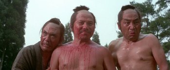 Movie still from “Lone Wolf and Cub: Baby Cart to Hades” (1972), directed by Kenji Misumi – A group of people with blood all over their faces; Medium shot, Low angle