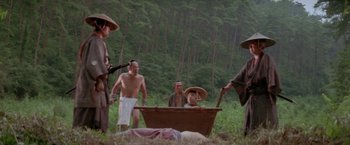 Movie still from “Lone Wolf and Cub: Baby Cart to Hades” (1972), directed by Kenji Misumi – A group of men standing next to each other in the grass; Wide shot, Low angle