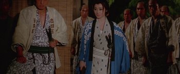 Movie still from “Lone Wolf and Cub: Baby Cart to Hades” (1972), directed by Kenji Misumi – A group of people standing next to each other; Medium shot, Over the shoulder angle