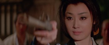 Movie still from “Lone Wolf and Cub: Baby Cart to Hades” (1972), directed by Kenji Misumi – A person holding a gun; Close Up shot, High angle