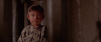 Movie still from “Lone Wolf and Cub: Baby Cart to Hades” (1972), directed by Kenji Misumi – A little boy standing in front of a wall; Close Up shot, Low angle