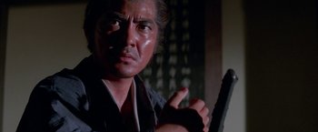 Movie still from “Lone Wolf and Cub: Baby Cart to Hades” (1972), directed by Kenji Misumi – A person holding a sword; Close Up shot, Low angle