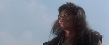 Movie still from “Lone Wolf and Cub: Baby Cart to Hades” (1972), directed by Kenji Misumi – A man with long brown hair looking up at the sky; Close Up shot, Low angle