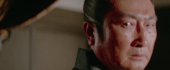 Movie still from “Lone Wolf and Cub: Baby Cart to Hades” (1972), directed by Kenji Misumi – A man's face with red paint on it; Close Up shot, Low angle