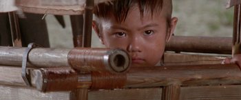 Movie still from “Lone Wolf and Cub: Baby Cart to Hades” (1972), directed by Kenji Misumi – A little boy is looking over a wooden fence; Close Up shot, High angle