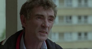 Movie still from “Looking for Eric” (2009), directed by Ken Loach – An older man is looking into the camera; Close Up shot, Low angle