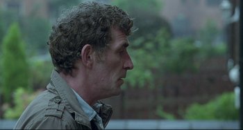 Movie still from “Looking for Eric” (2009), directed by Ken Loach – A person wearing a jacket; Close Up shot, Over the shoulder angle