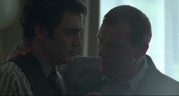 Movie still from “Looking for Eric” (2009), directed by Ken Loach – A man and a boy are looking at one another; Close Up shot, Over the shoulder angle