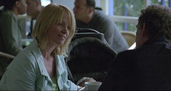 Movie still from “Looking for Eric” (2009), directed by Ken Loach – A woman sitting at a table in front of a laptop computer; Close Up shot, Over the shoulder angle