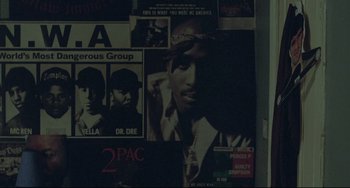 Movie still from “Looking for Eric” (2009), directed by Ken Loach – A black and white photo of a tupac shakur poster; Extreme Close Up shot, Overhead angle