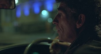 Movie still from “Looking for Eric” (2009), directed by Ken Loach – A person sitting in a car; Close Up shot, Low angle