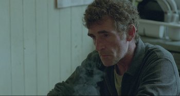 Movie still from “Looking for Eric” (2009), directed by Ken Loach – A person smoking a cigarette; Close Up shot, Over the shoulder angle
