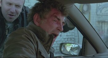 Movie still from “Looking for Eric” (2009), directed by Ken Loach – A man in a car with his mouth wide open; Close Up shot, Over the shoulder angle