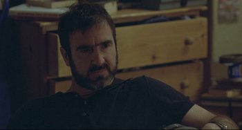 Movie still from “Looking for Eric” (2009), directed by Ken Loach – A person sitting in a chair; Close Up shot, Over the shoulder angle