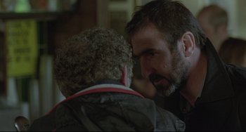 Movie still from “Looking for Eric” (2009), directed by Ken Loach – A man talking to another man in front of a mirror; Close Up shot, Over the shoulder angle