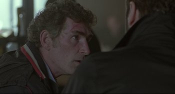 Movie still from “Looking for Eric” (2009), directed by Ken Loach – A person wearing a jacket; Close Up shot, Over the shoulder angle