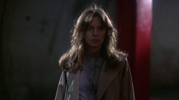 A woman with long brown hair wearing a jacket