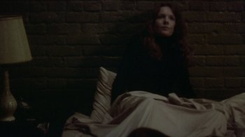 Movie still from “Looking for Mr. Goodbar” (1977), directed by Richard Brooks – A woman sitting in a bed under a blanket; Medium shot, High angle
