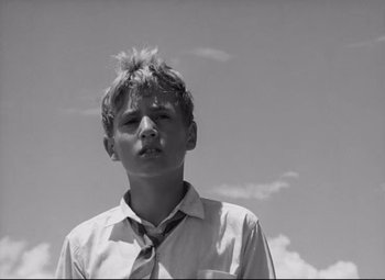 Movie still from “Lord of the Flies” (1963), directed by Peter Brook – Black and white photograph of a young boy with a mohawk; Close Up shot, Low angle