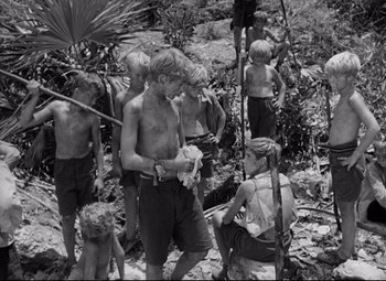 Movie still from “Lord of the Flies” (1963), directed by Peter Brook – A black and white photo of a group of young people; Wide shot, High angle