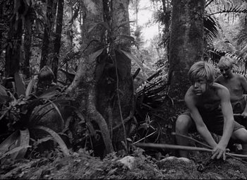 Movie still from “Lord of the Flies” (1963), directed by Peter Brook – Two young boys in the woods looking at the camera; Wide shot, Low angle