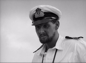 Movie still from “Lord of the Flies” (1963), directed by Peter Brook – Black and white photograph of a man wearing a hat; Close Up shot, Low angle